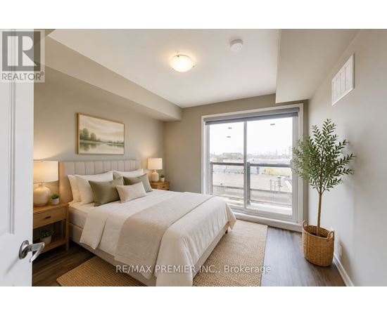 A bedroom with a large bed and a window overlooking a parking lot.