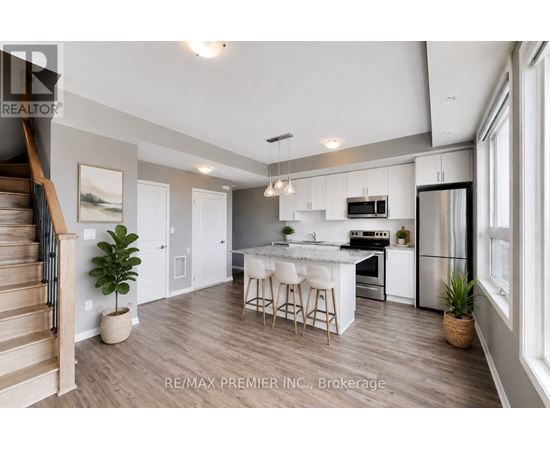 A modern kitchen with white cabinets and a center island.