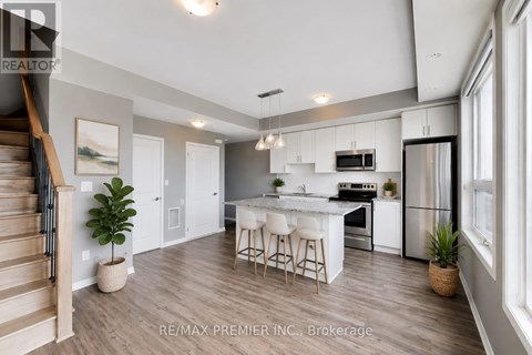 A modern kitchen with white cabinets and a center island.