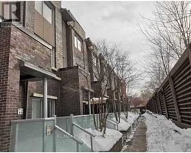 A snowy pathway leads to a brick building with a sign that reads "RE/MAX Prime Properties, Brokerage.".