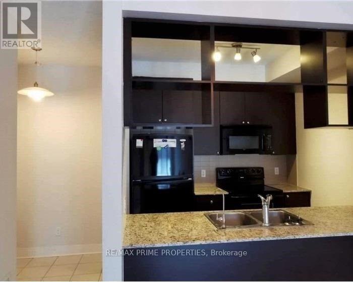 A kitchen with granite countertops and stainless steel appliances.
