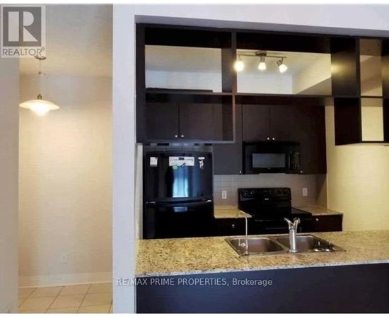 A kitchen with granite countertops and stainless steel appliances.