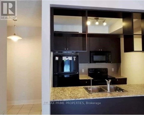 A kitchen with granite countertops and stainless steel appliances.