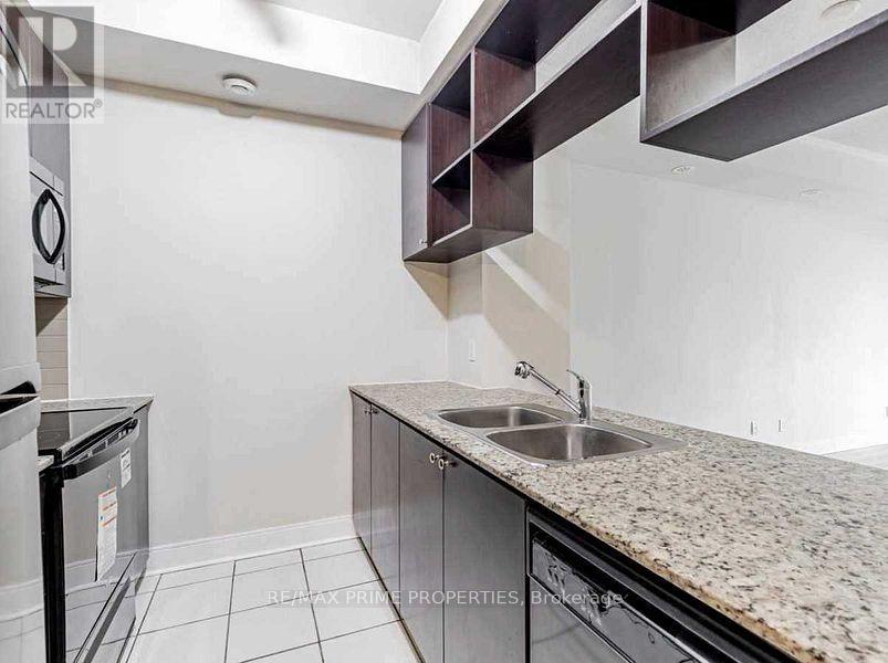 A kitchen with granite countertops and stainless steel appliances.