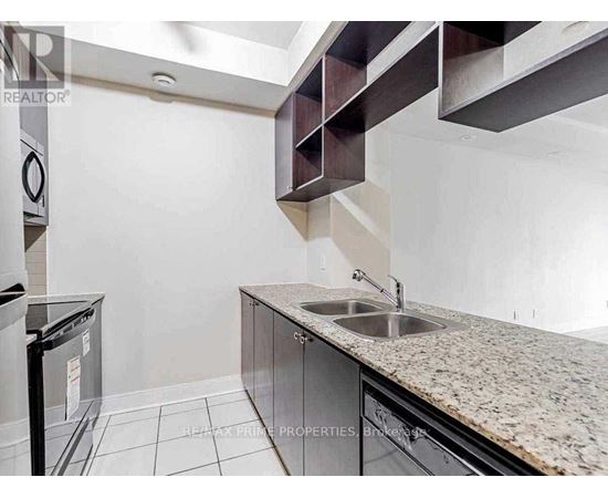 A kitchen with granite countertops and stainless steel appliances.