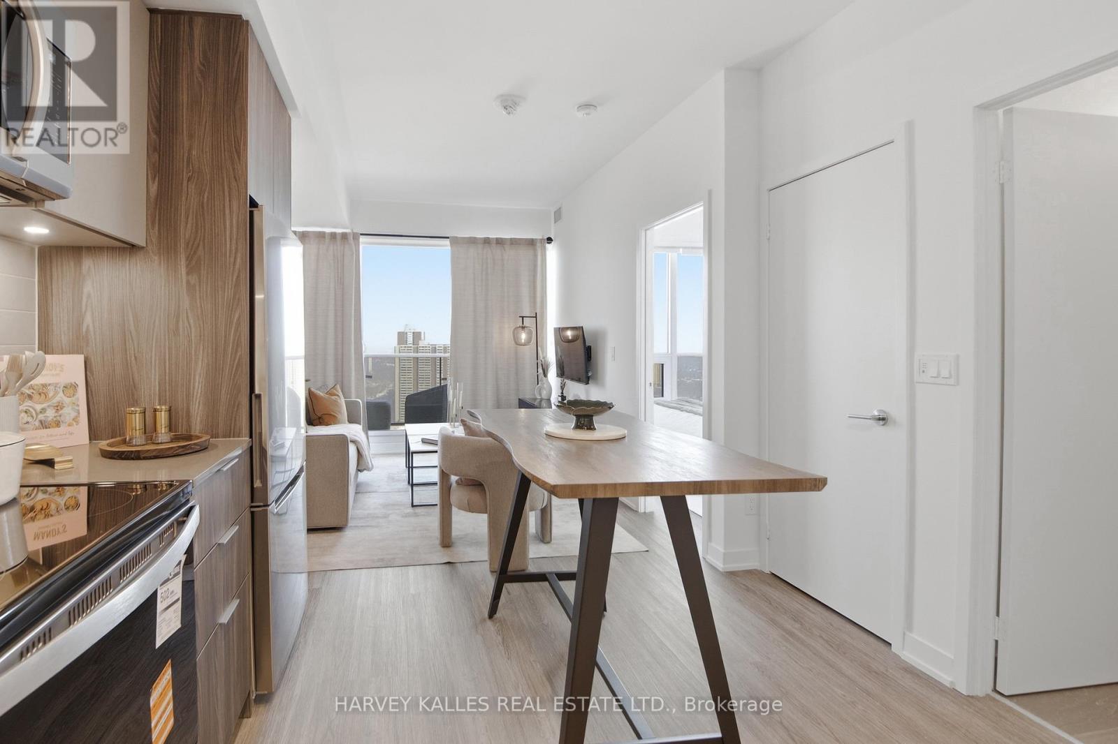A modern kitchen with a dining table and chairs.