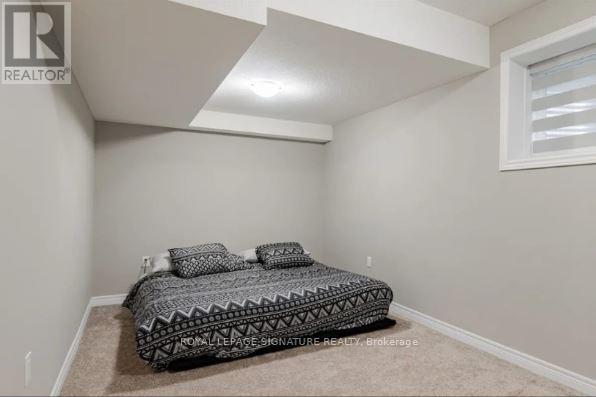 A bedroom with a bed and a window.