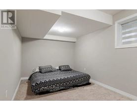 A bedroom with a bed and a window.