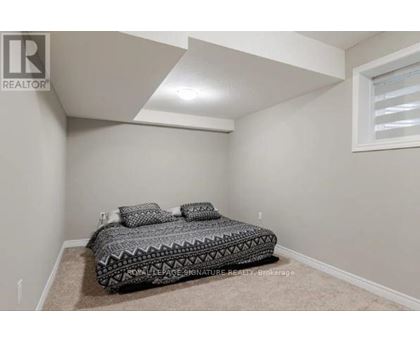 A bedroom with a bed and a window.