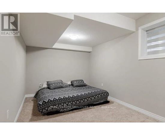 A bedroom with a bed and a window.