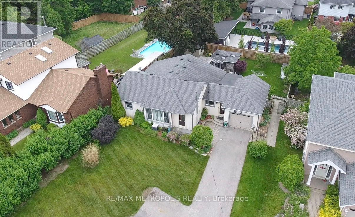 A bird's eye view of a residential area with houses and a swimming pool.