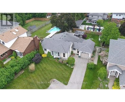 A bird's eye view of a residential area with houses and a swimming pool.
