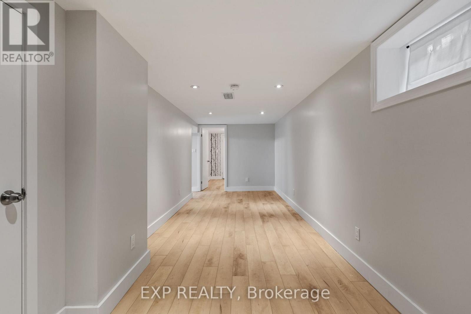 A long hallway with EXP REALTY, Brokerage written on the bottom.