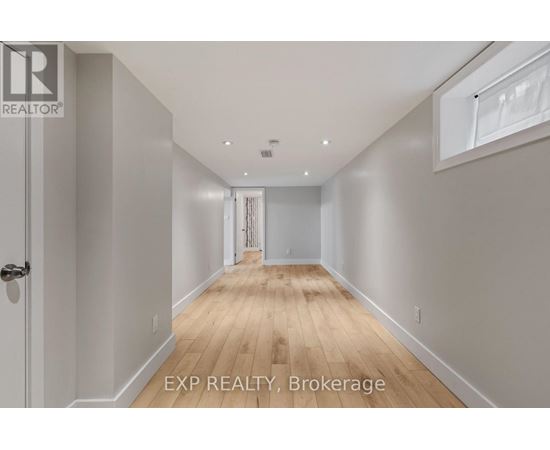A long hallway with EXP REALTY, Brokerage written on the bottom.