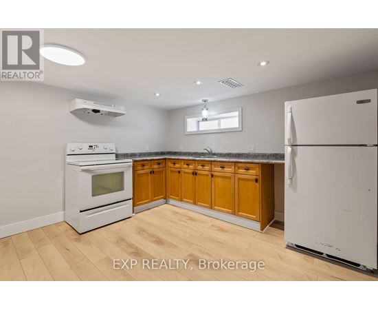 A kitchen with wooden cabinets and white appliances.