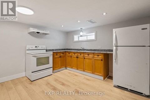A kitchen with wooden cabinets and white appliances.