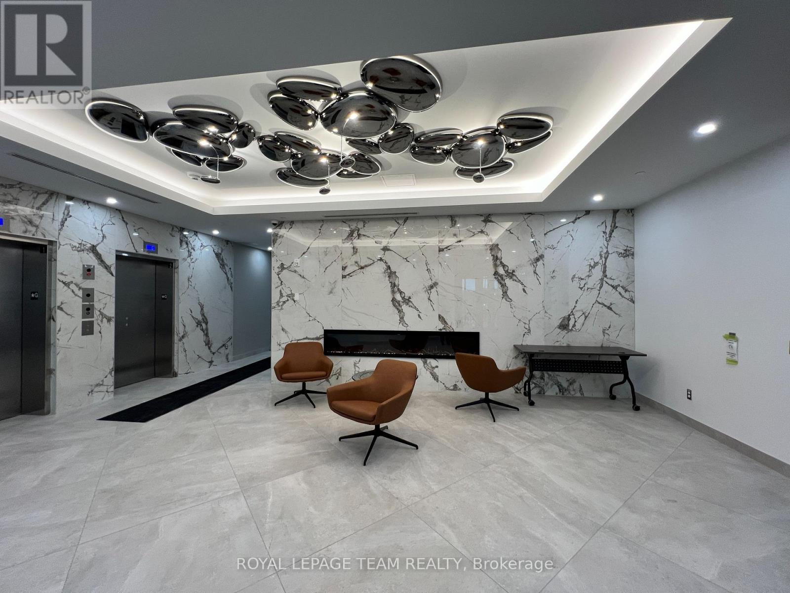 A modern office lobby with marble walls and a bench.
