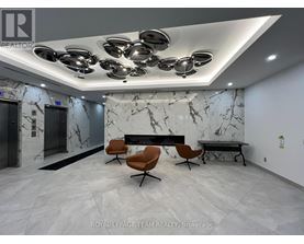 A modern office lobby with marble walls and a bench.