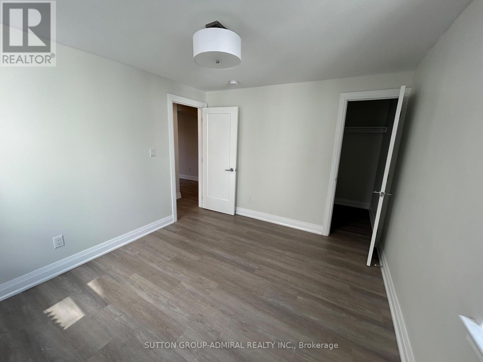 A room with a white ceiling and a wooden floor.
