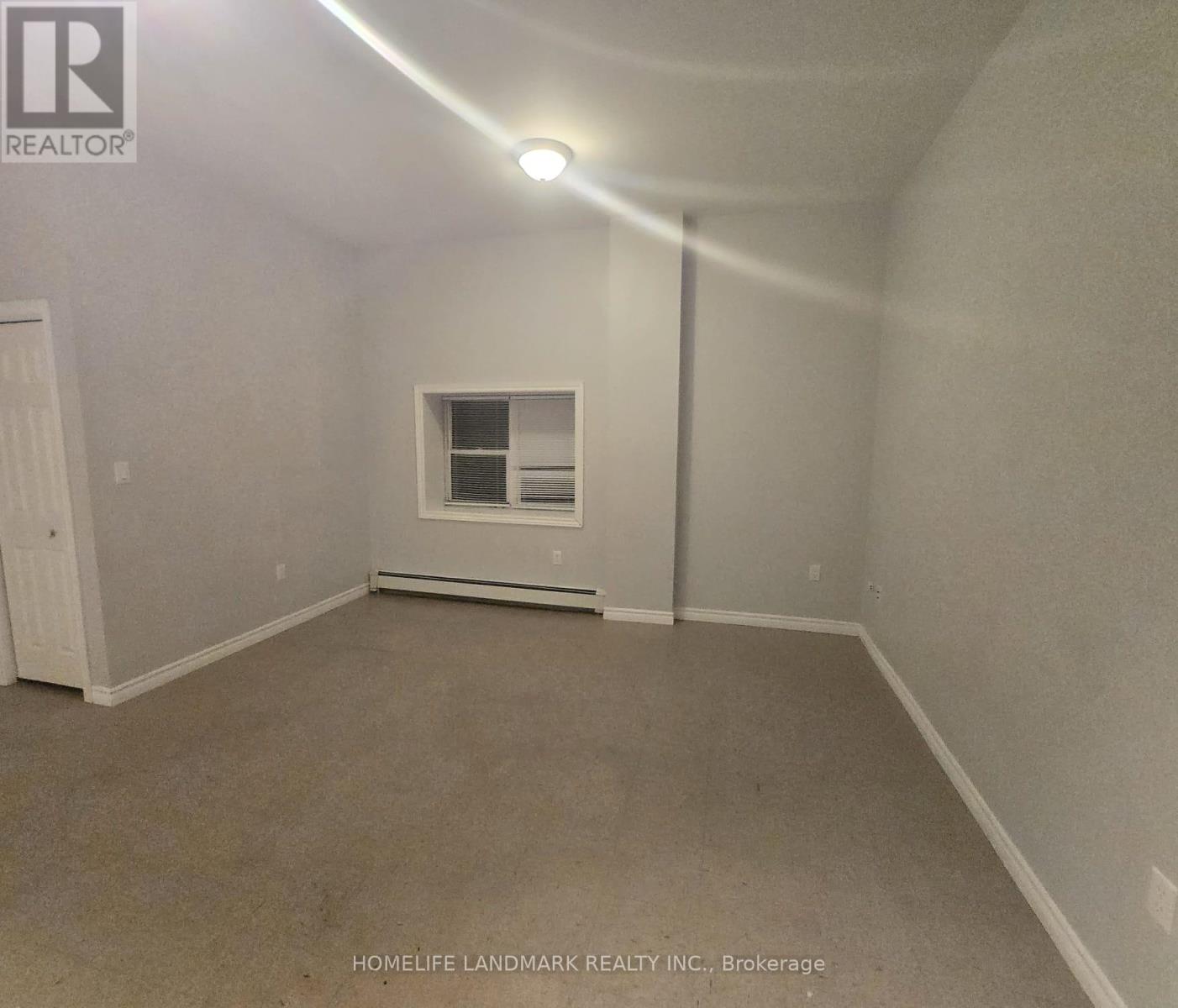 A room with a window and a door.