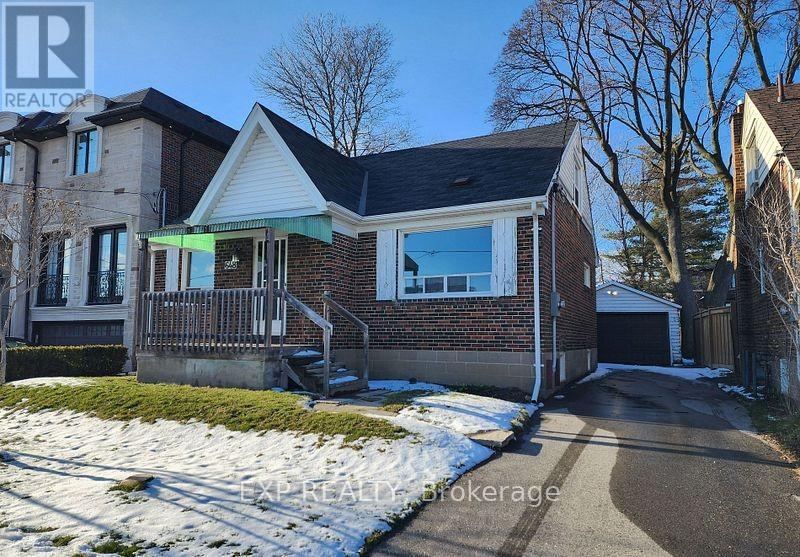 A house with a driveway and snow on the ground.