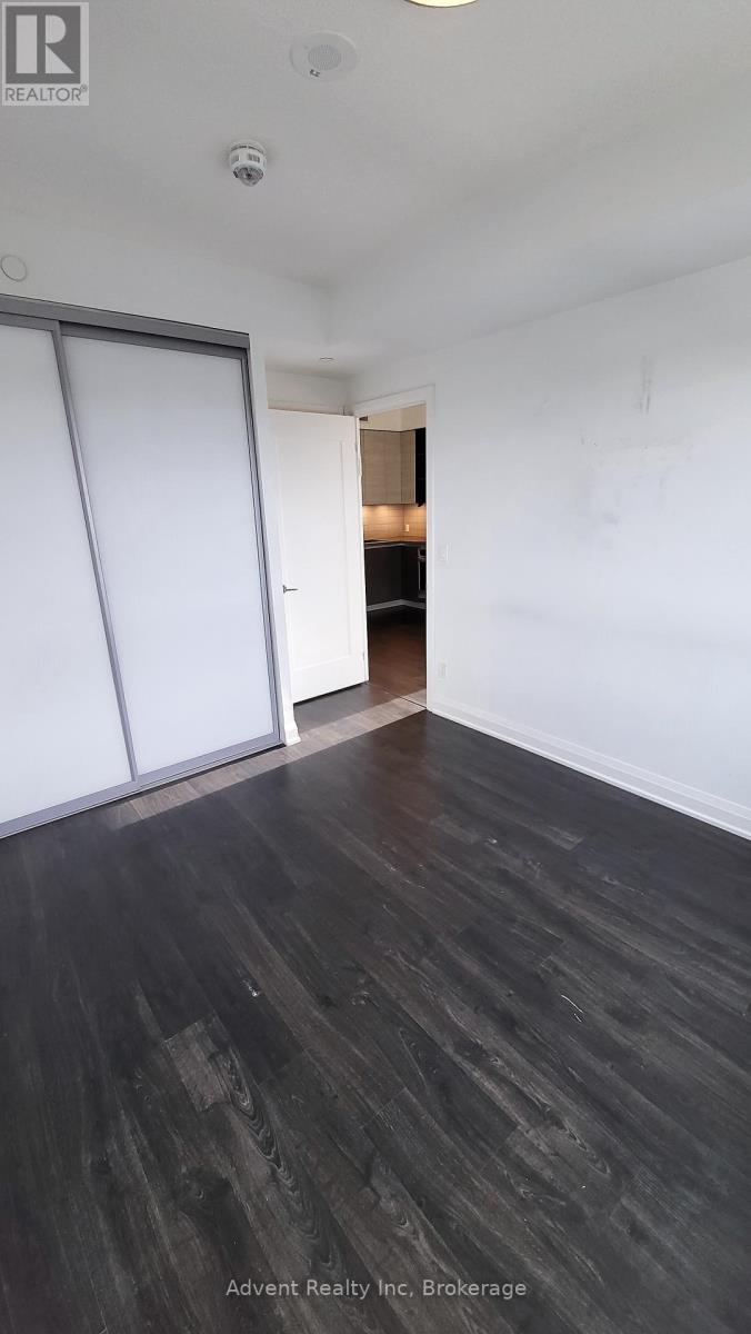 A room with a sliding door and wood flooring.