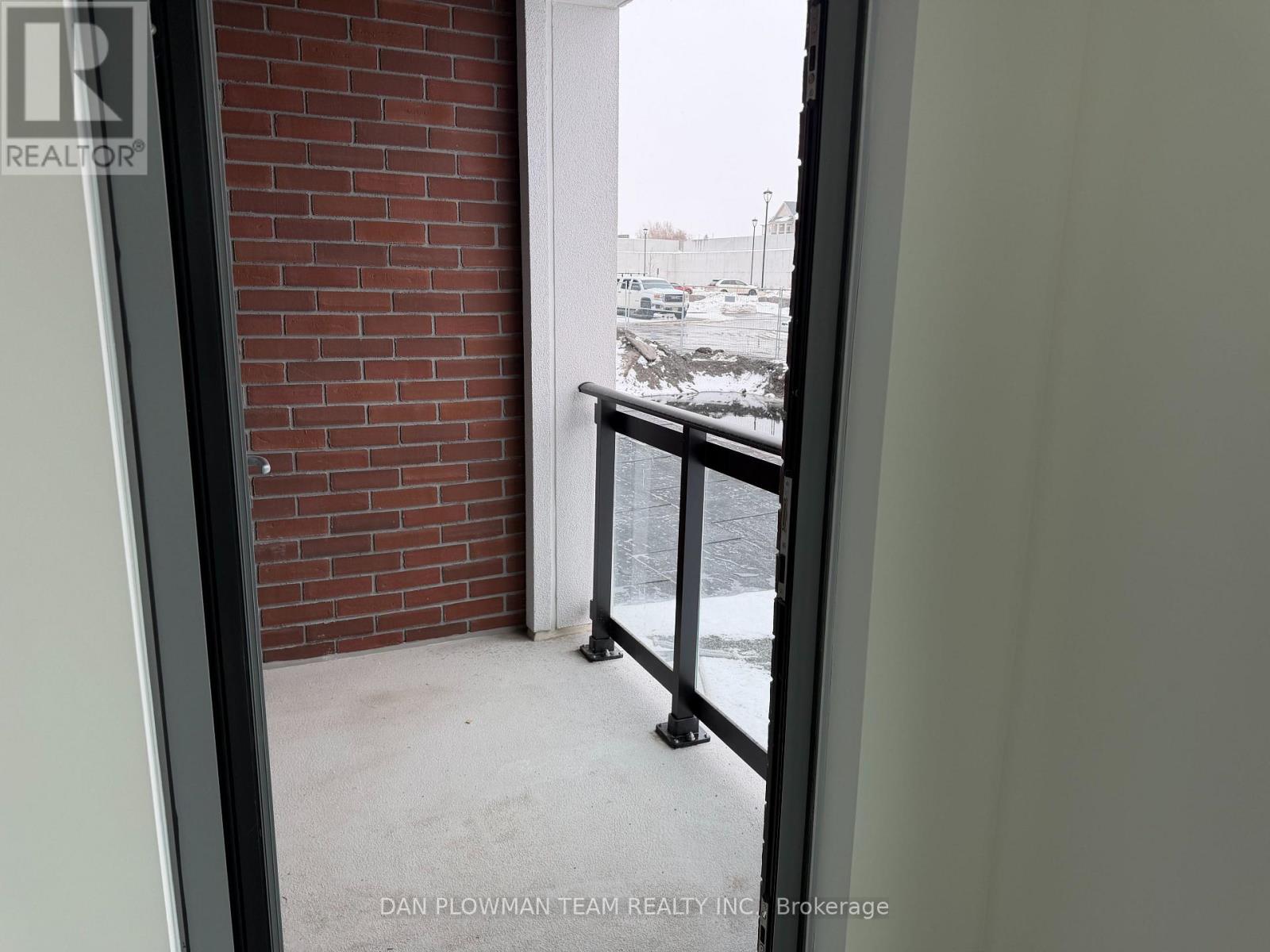 A view from inside a building looking out to a snowy parking lot.