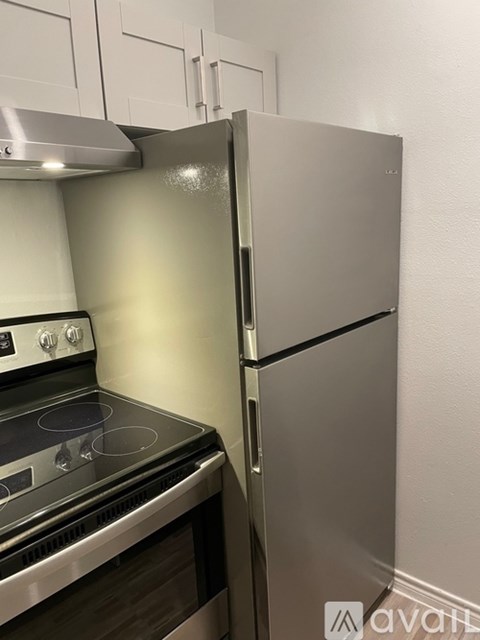 A kitchen with a stove and a refrigerator.