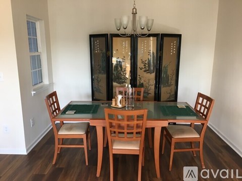 A dining room with a glass table and chairs.