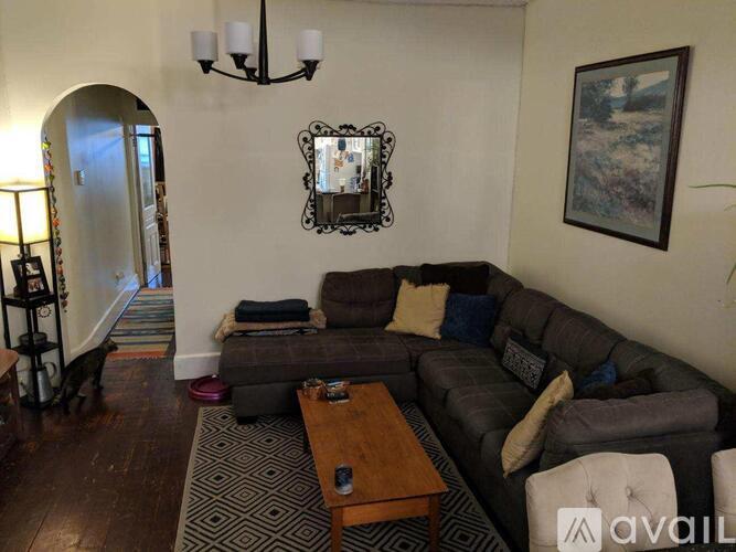 A living room with a grey couch and a coffee table.