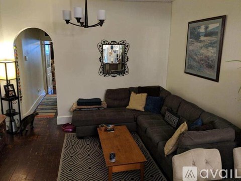 A living room with a grey couch and a coffee table.