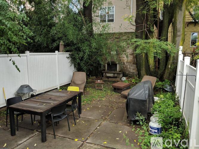 A backyard with a table and chairs.