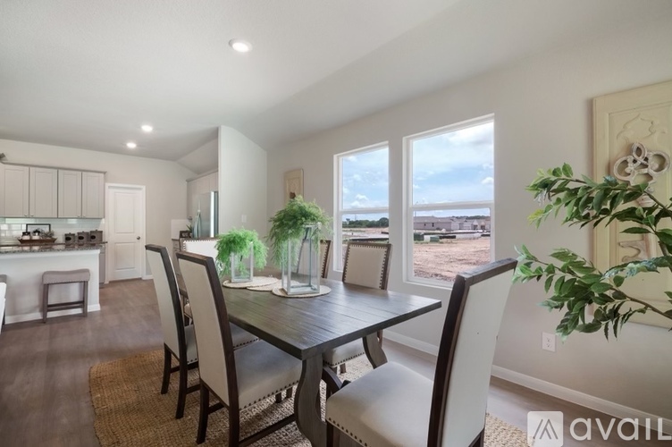 A dining room with a table and chairs is available for rent.