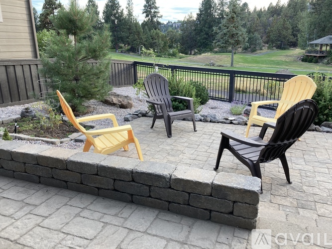Four chairs are placed on a patio.