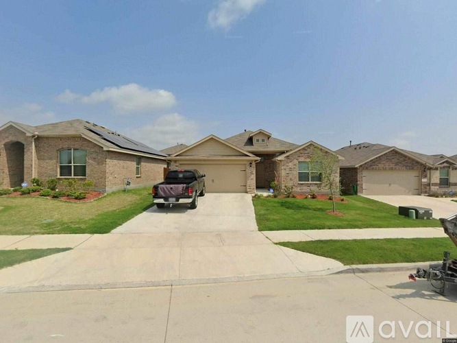 A house with a driveway and a car is for sale.