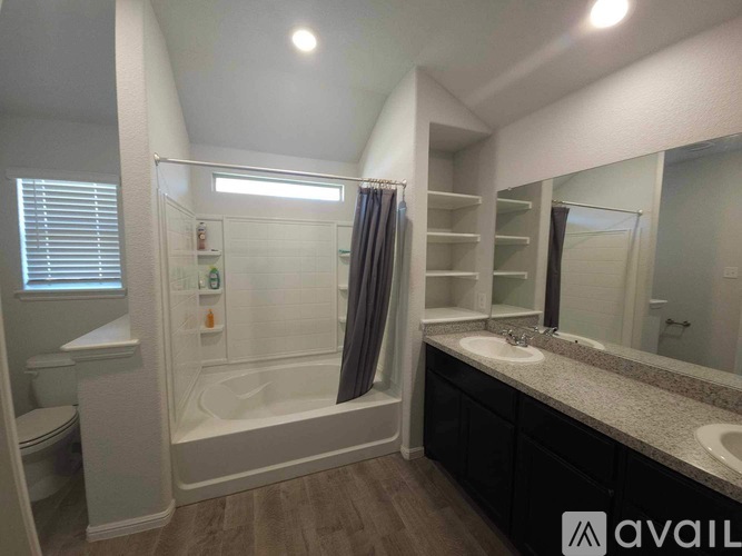 A bathroom with a white tub, sink, and toilet.