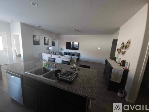 A kitchen with a sink, dishwasher, and a countertop with a towel on it.