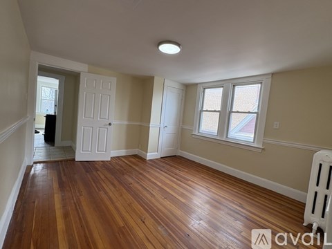A room with wooden floors and a window.