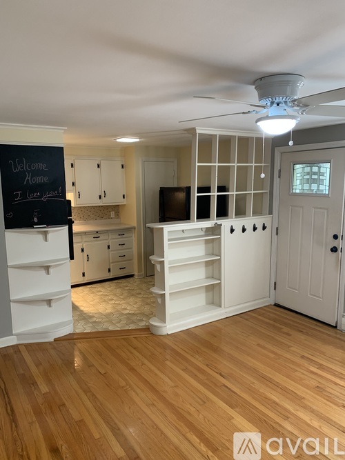 A room with a chalkboard that says "Welcome Home" and a TV.