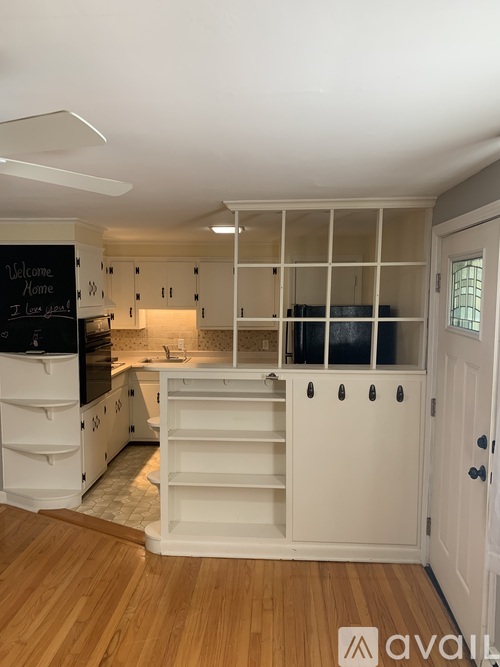 A kitchen with a chalkboard sign that says "Welcome Home" and a logo that says "avail" in the bottom right corner.