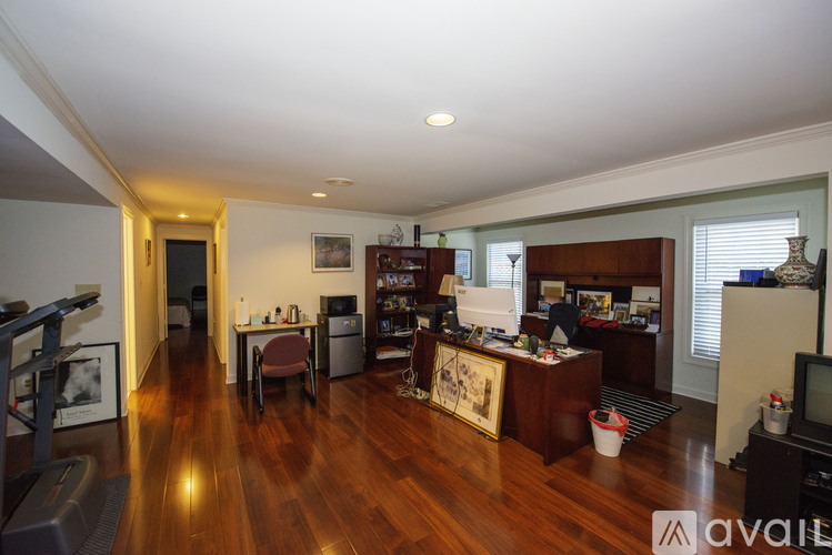 A living room with a wooden floor and furniture.