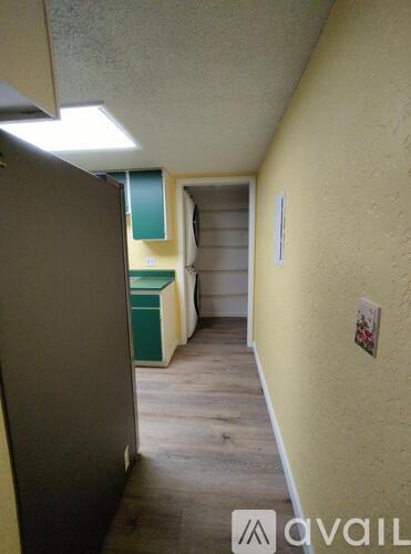 A hallway with a yellow wall and a white door.