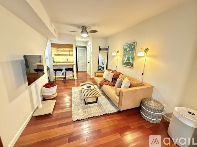 A living room with a couch, a coffee table, and a rug.