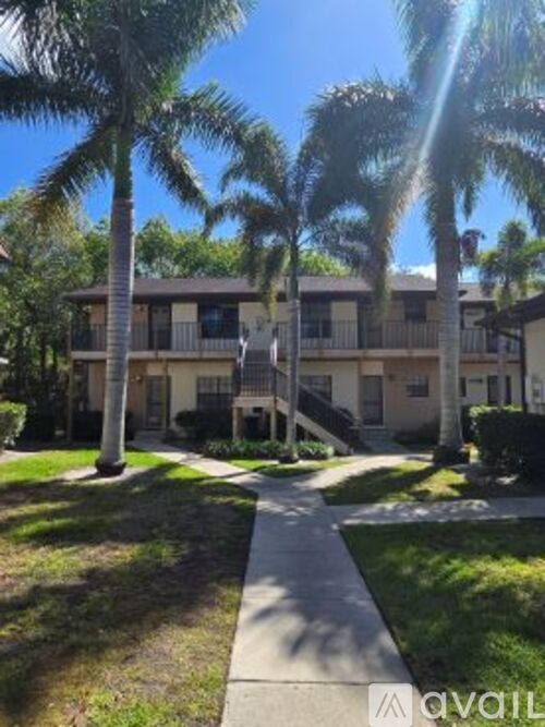 A sunny day at a residential area with apartment buildings and palm trees.