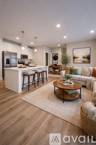 A modern kitchen with a breakfast bar and a dining table with chairs.