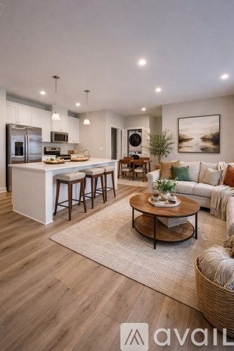 A modern kitchen with a breakfast bar and a dining table with chairs.