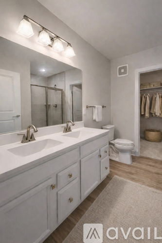 A bathroom with a white sink and a white toilet.