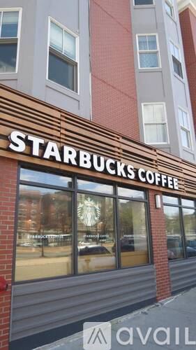 A Starbucks Coffee sign is on a building.