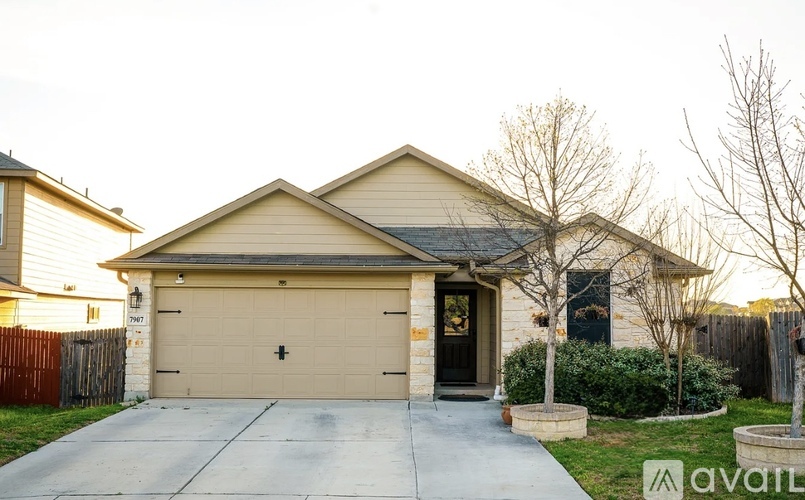 A house with a garage and a driveway in front.