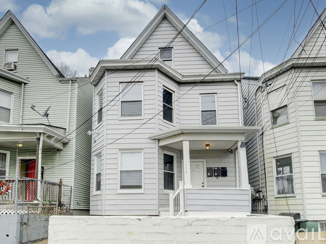 A grey house with a white door and windows.